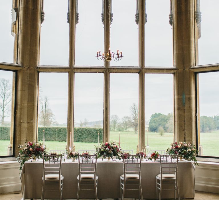 Reception Table with Taper Candles &amp; Low Floral Arrangements | Blush &amp; Burgundy Floral Fairytale Wedding Inspiration at Grittleton House Planned &amp; Styled by Jennifer Louise Weddings | Katherine Yiannaki Photography