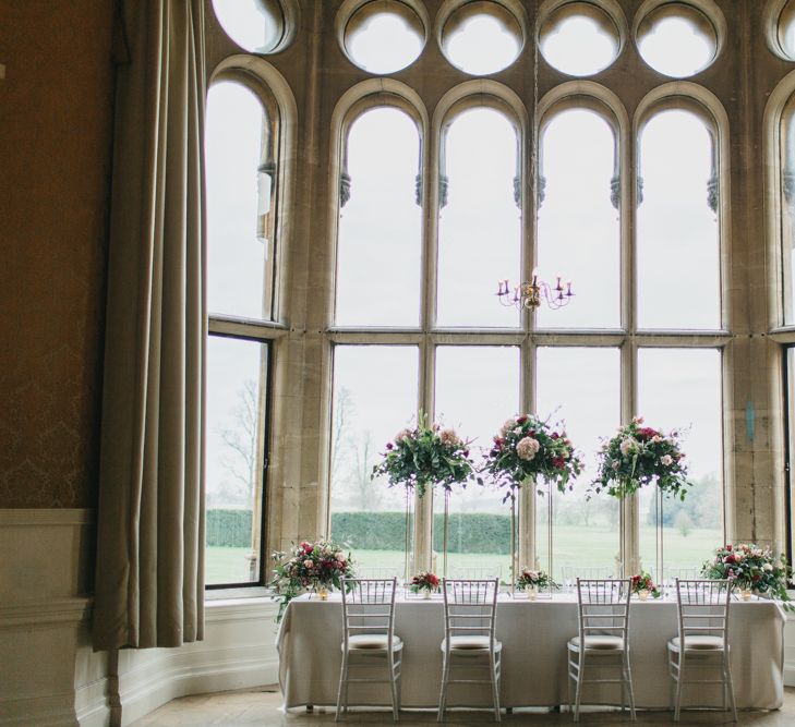 Reception Table Decor with Taper Candles &amp; High Floral Arrangements | Blush &amp; Burgundy Floral Fairytale Wedding Inspiration at Grittleton House Planned &amp; Styled by Jennifer Louise Weddings | Katherine Yiannaki Photography