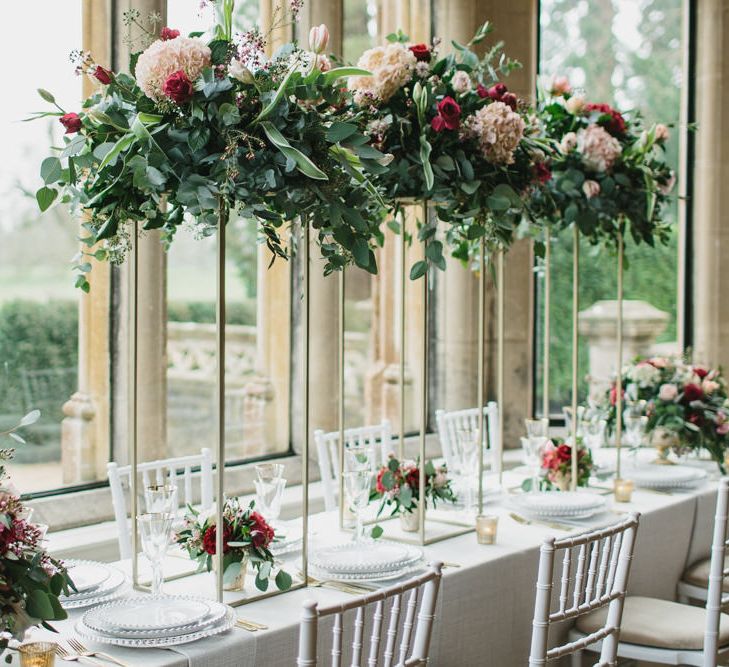 Reception Table Decor with Taper Candles &amp; High Floral Arrangements | Blush &amp; Burgundy Floral Fairytale Wedding Inspiration at Grittleton House Planned &amp; Styled by Jennifer Louise Weddings | Katherine Yiannaki Photography