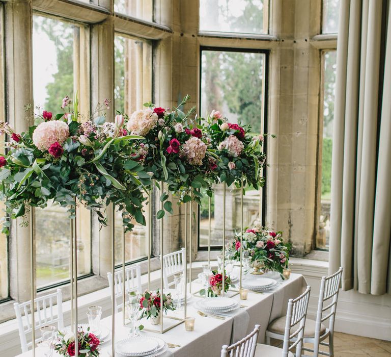 Reception Table Decor with Taper Candles &amp; High Floral Arrangements | Blush &amp; Burgundy Floral Fairytale Wedding Inspiration at Grittleton House Planned &amp; Styled by Jennifer Louise Weddings | Katherine Yiannaki Photography