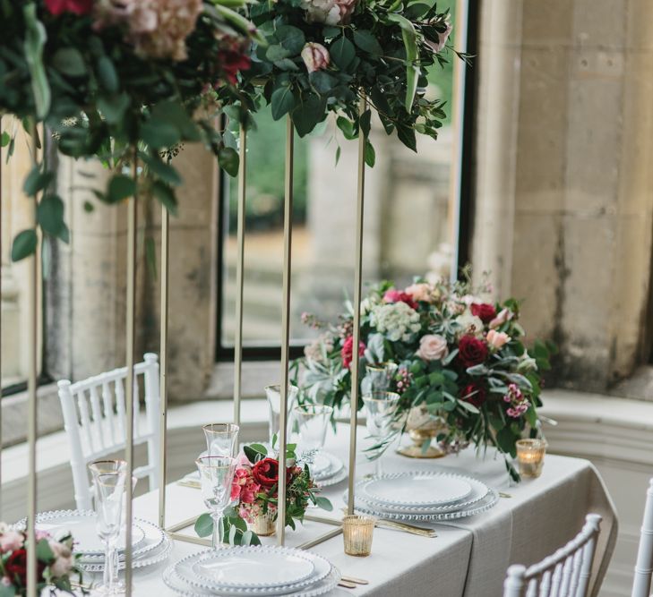 Reception Table Decor with Taper Candles &amp; High Floral Arrangements | Blush &amp; Burgundy Floral Fairytale Wedding Inspiration at Grittleton House Planned &amp; Styled by Jennifer Louise Weddings | Katherine Yiannaki Photography