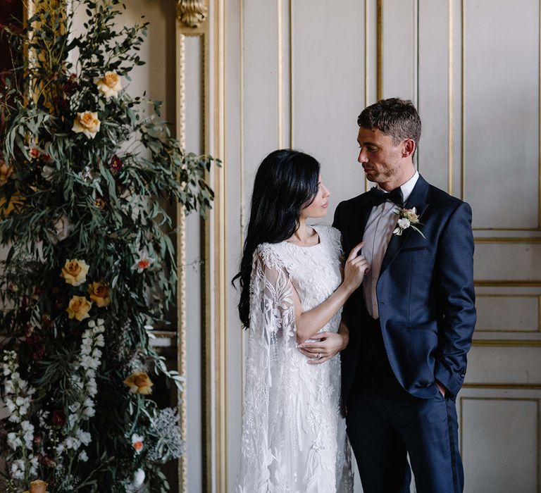 Stylish Bride and Groom at the Floral Altar in St Giles House