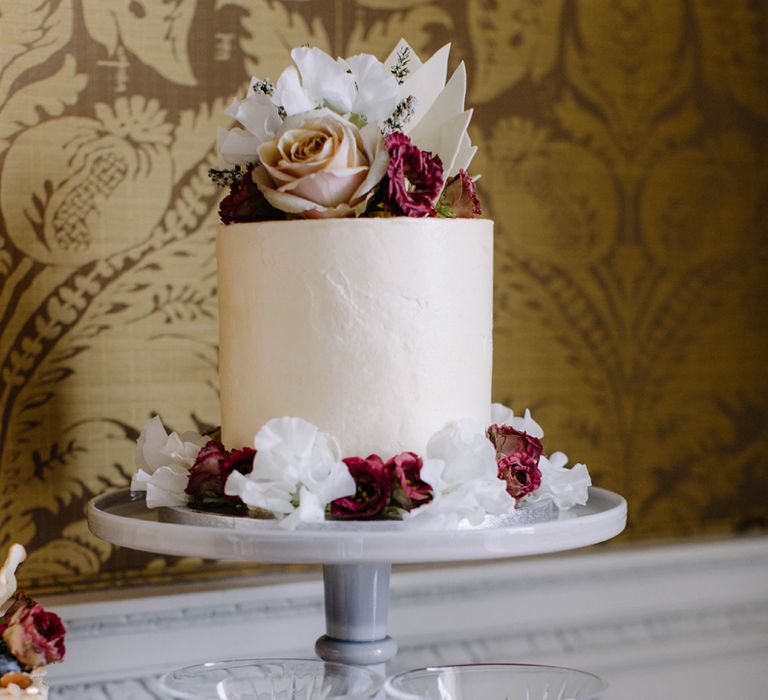 Single Tier Wedding Cake on Cake Stand with Floral Skirt.