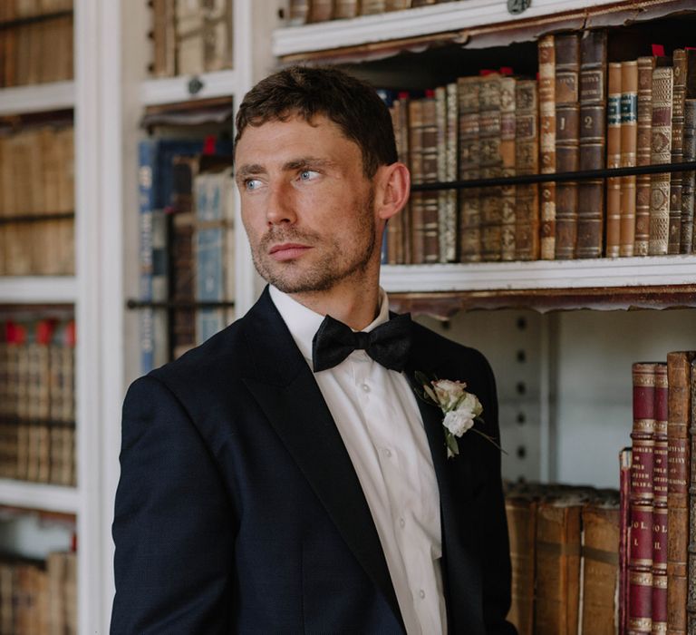 Groom in Black Marc Wallace Tuxedo with Bow Tie