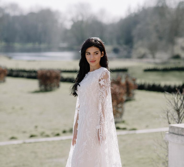 Bride in Intricate Lace and Applique Wedding Dress with Long Bell Sleeves