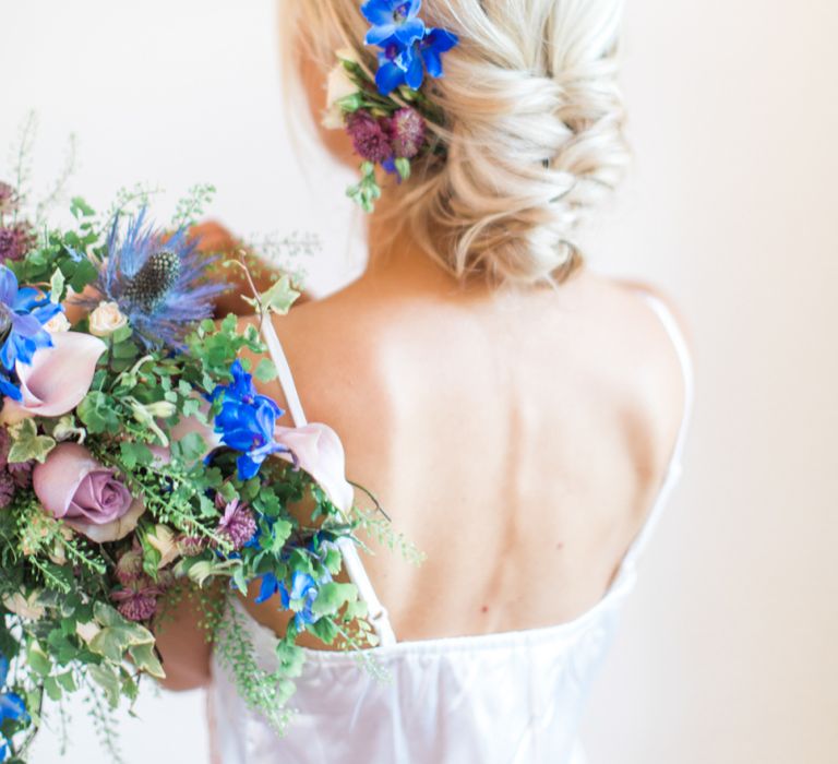 Bride with delphiniums in updo hairstyle