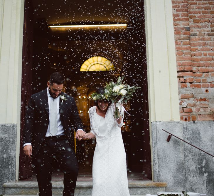 Confetti Moment | Bride in Laure De Sagazan Gown | Groom in Black Suit | Green &amp; White Bohemian Wedding in the Rain at Castello di San Sebastiano da Po, Italy | Margherita Calati Photography | Second Shooter Carlo Vittorio