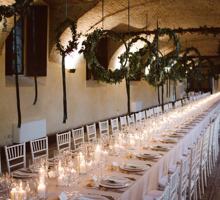 Greenery Hanging Hoops &amp; Candle Light Wedding Reception Decor | Green &amp; White Bohemian Wedding in the Rain at Castello di San Sebastiano da Po, Italy | Margherita Calati Photography | Second Shooter Carlo Vittorio