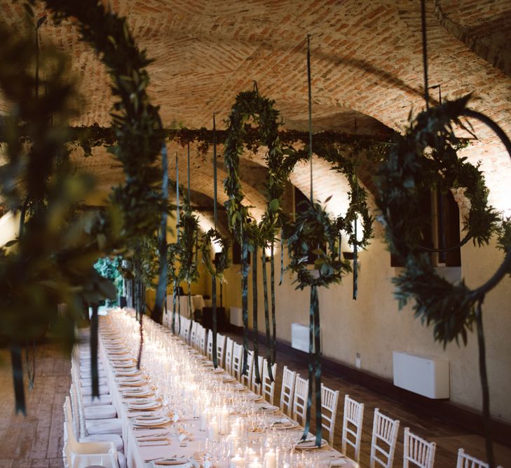 Greenery Hanging Hoops &amp; Candle Light Wedding Reception Decor | Green &amp; White Bohemian Wedding in the Rain at Castello di San Sebastiano da Po, Italy | Margherita Calati Photography | Second Shooter Carlo Vittorio