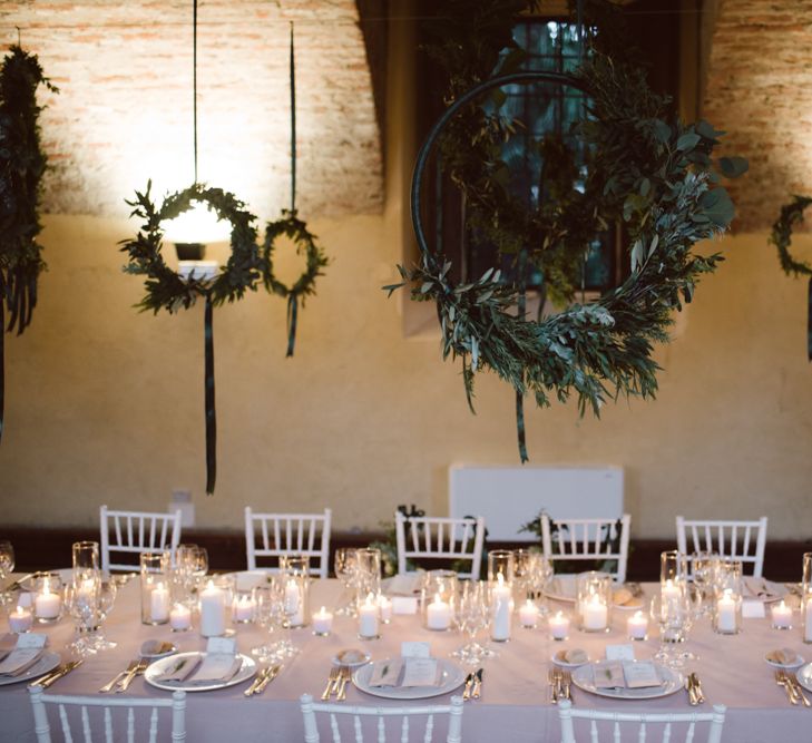 Greenery Hanging Hoops &amp; Candle Light Wedding Reception Decor | Green &amp; White Bohemian Wedding in the Rain at Castello di San Sebastiano da Po, Italy | Margherita Calati Photography | Second Shooter Carlo Vittorio