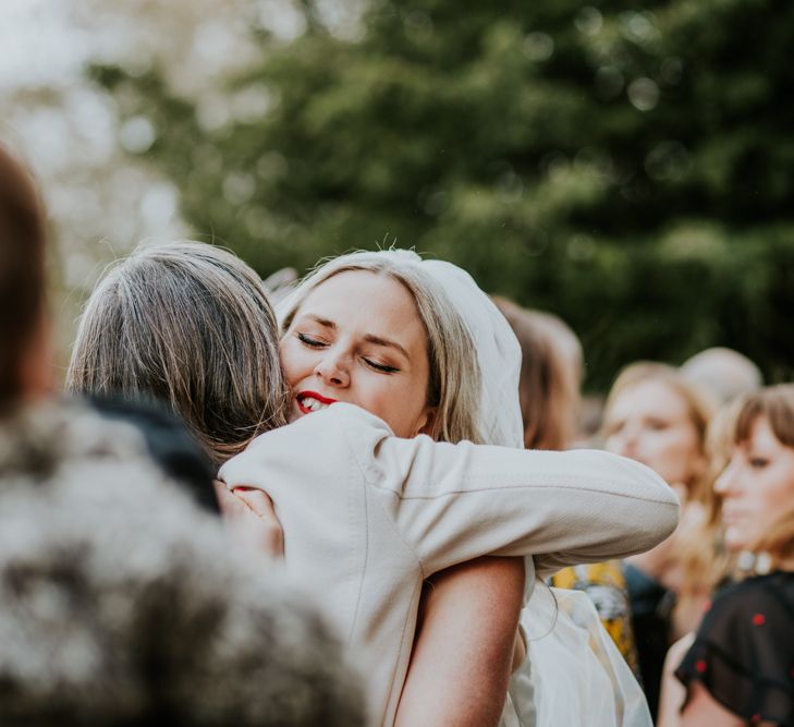 Bride greets wedding guests for hanging flowers decor wedding