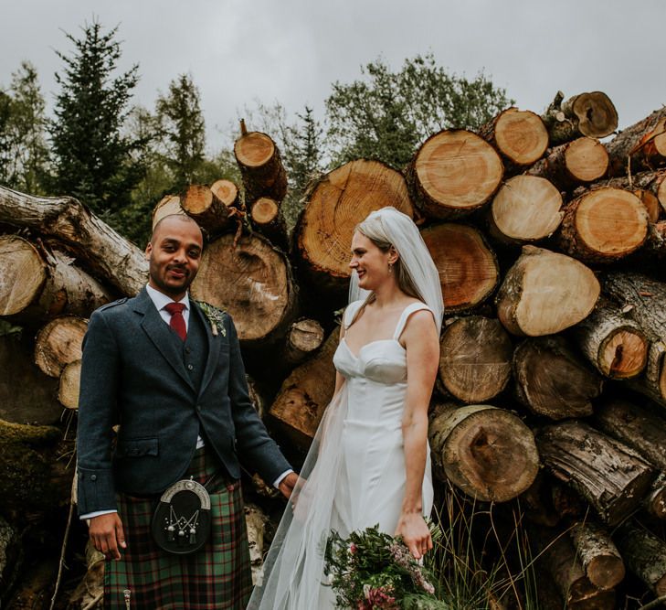 Bride and groom at marquee wedding with hanging flowers