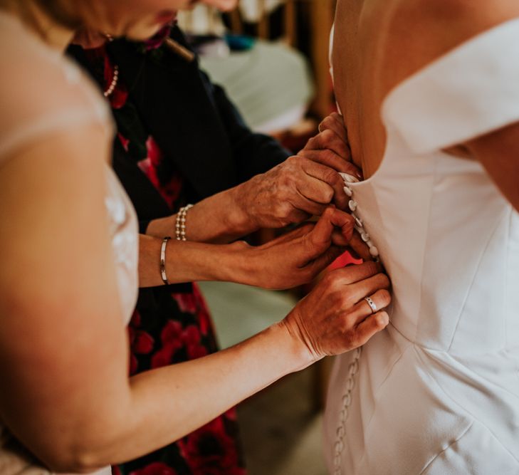 Bride gets her vegan fitted wedding dress on