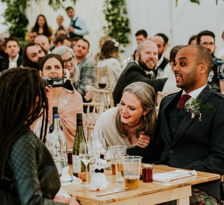 Bride and groom enjoy the wedding speeches