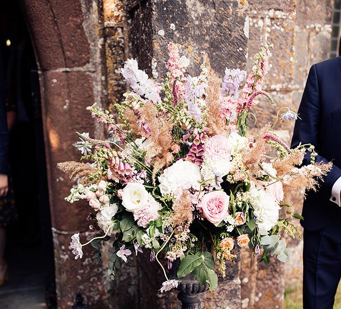 Romantic pink church wedding flower arrangement