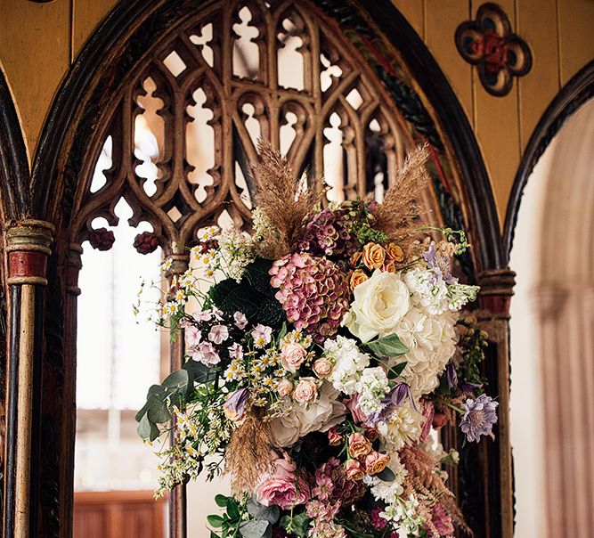 Church altar wedding flowers with pink and white stems for wedding with outdoor first dance