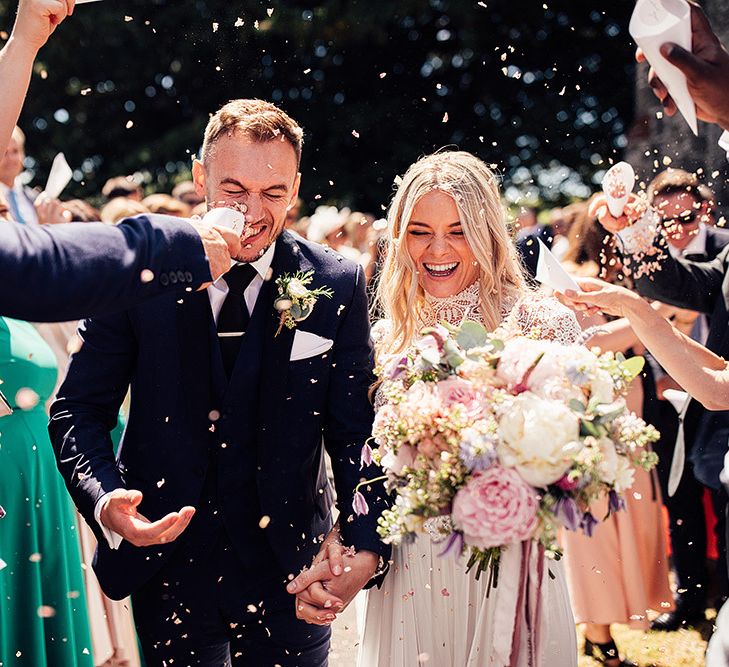 Confetti moment by Harry Michael Photography for wedding with outdoor first dance