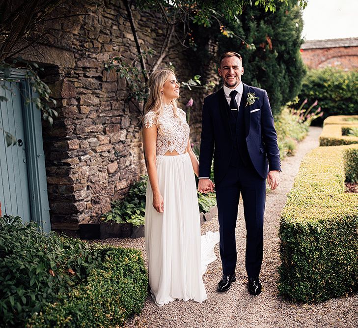 Bride and groom portrait with bride in a Julio Vino wedding dress and groom in navy suit for wedding with outdoor first dance