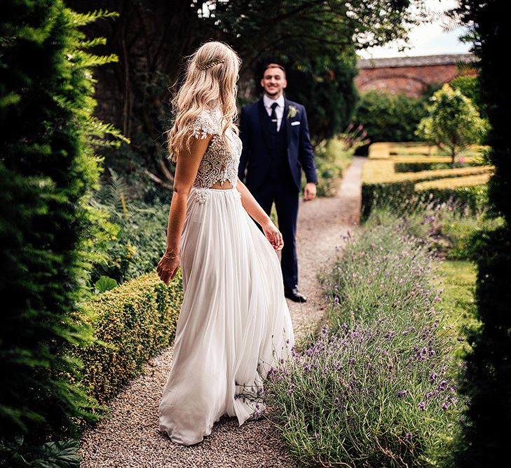 Bride in Julio Vino wedding dress walking through the gardens at Kingston Estate, Devon