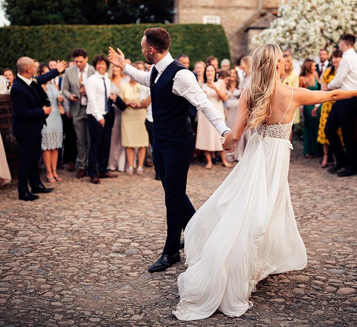 Outdoor wedding first dance with bride in Julio Vino wedding dress