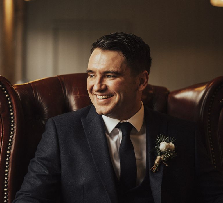 Happy Groom in Next Suit Sitting on Leather Chair