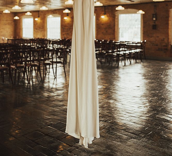 Hanging Charlie Brear Wedding Dress in Industrial Wedding Venue The West Mill