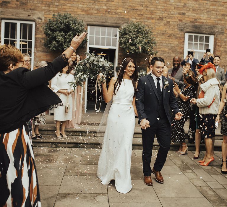 Confetti Exit at The West Mill Industrial Wedding Venue with Bride in Charlie Brear Wedding Dress and Groom in Next Suit