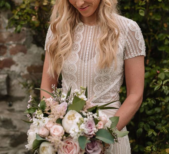 Bride wears Watters wedding dress and flower crown