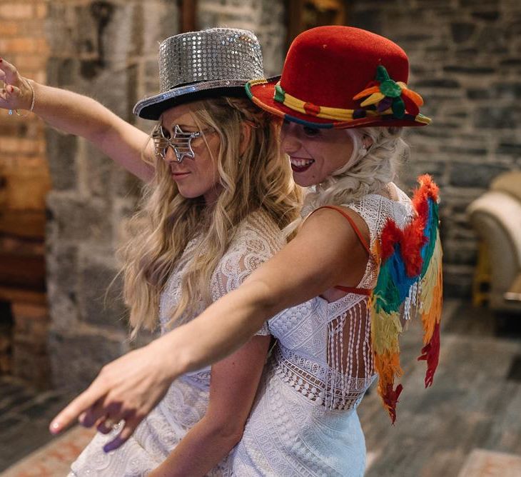 Brides pose with props at selfie mirror