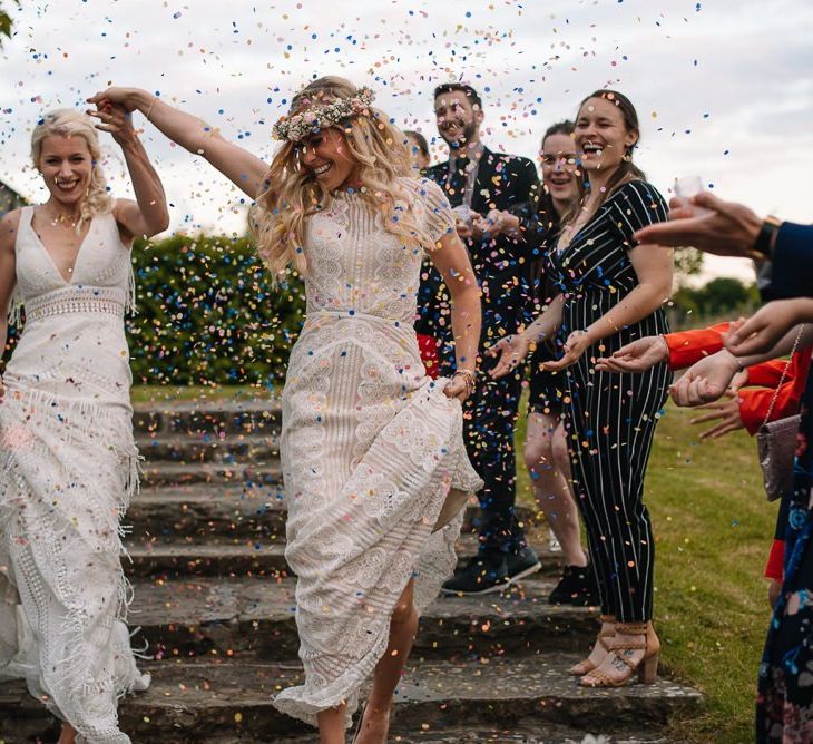 Confetti exit for brides wearing Watters wedding dress