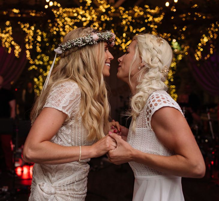 Bride and bride first dance with fairy light canopy at  Ballymagarvey Village in Ireland