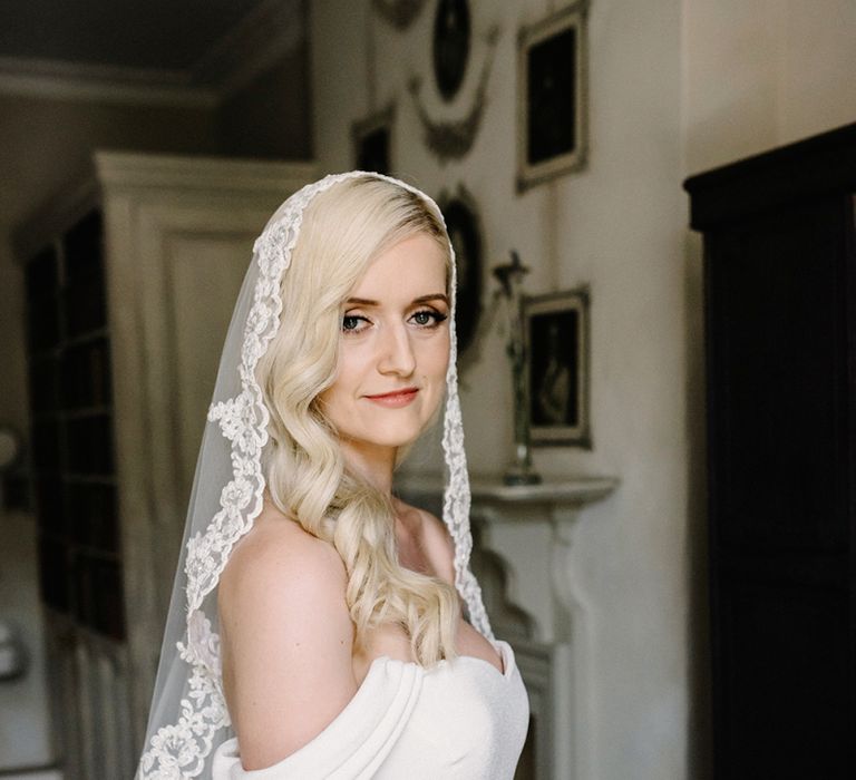 Beautiful Bride with Finger Waves hair, Lace Edged Wedding Veil and Fitted Pronovias Raciela Wedding Dress