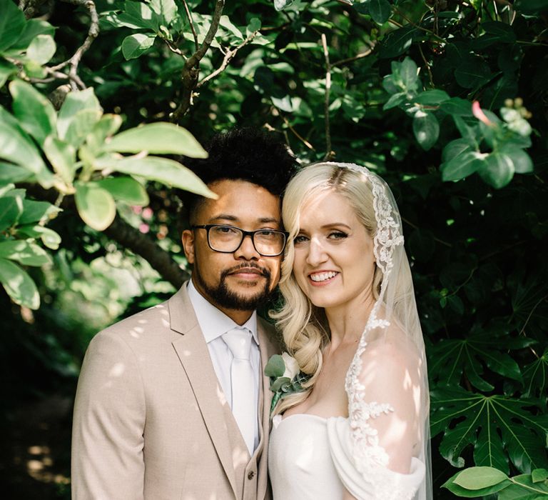 Beautiful Bride in Bardot Pronovias Wedding Dress and Groom in Beige Moss Bros. Suit