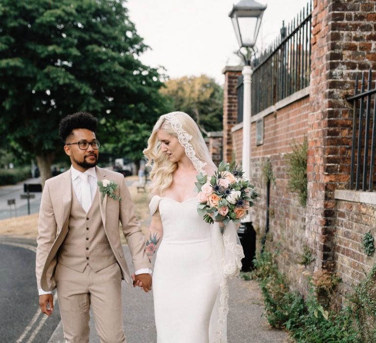 Bride in Pronovias Wedding Dress and Groom in a Beige Moss Bros. Suit