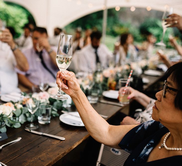 Wedding Guests Raising Their Glasses During the Speeches