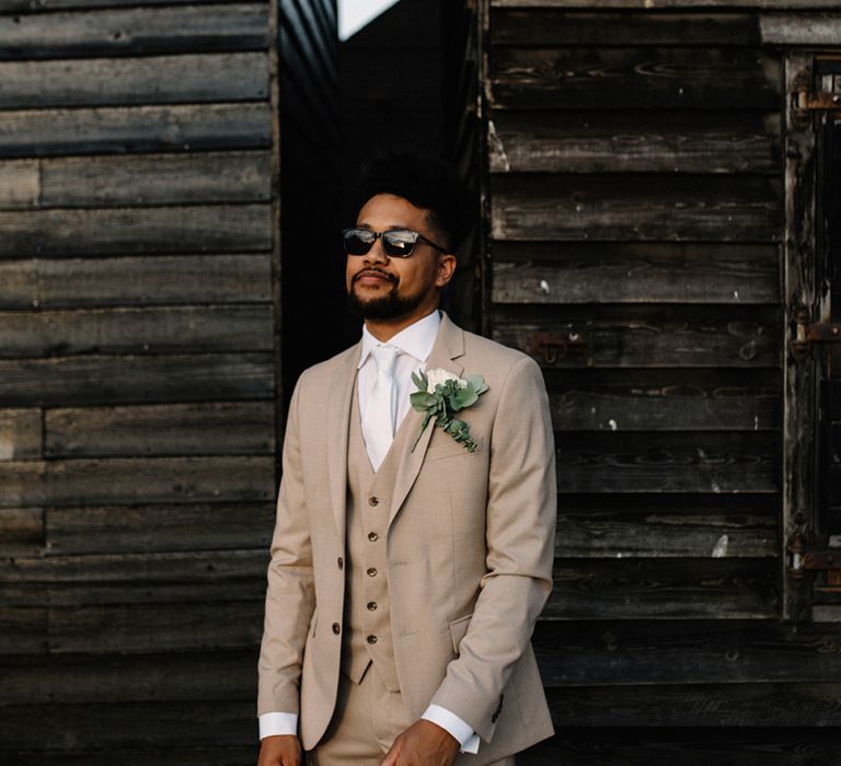 Stylish Groom in Beige Moss Bros. Three-Piece Wedding Suit