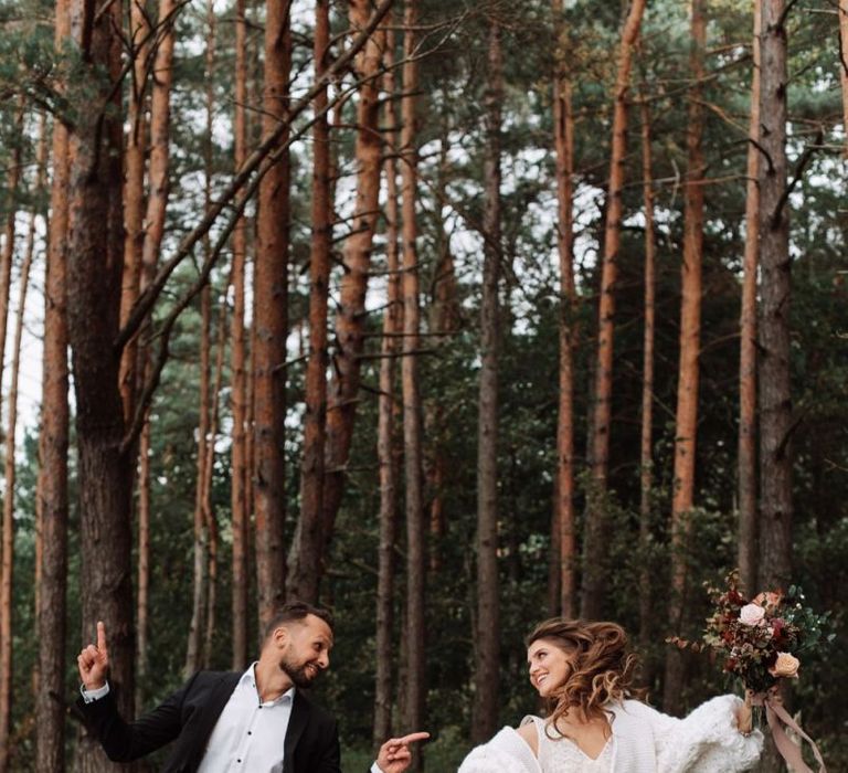 Bride and Groom Skipping in the Woods