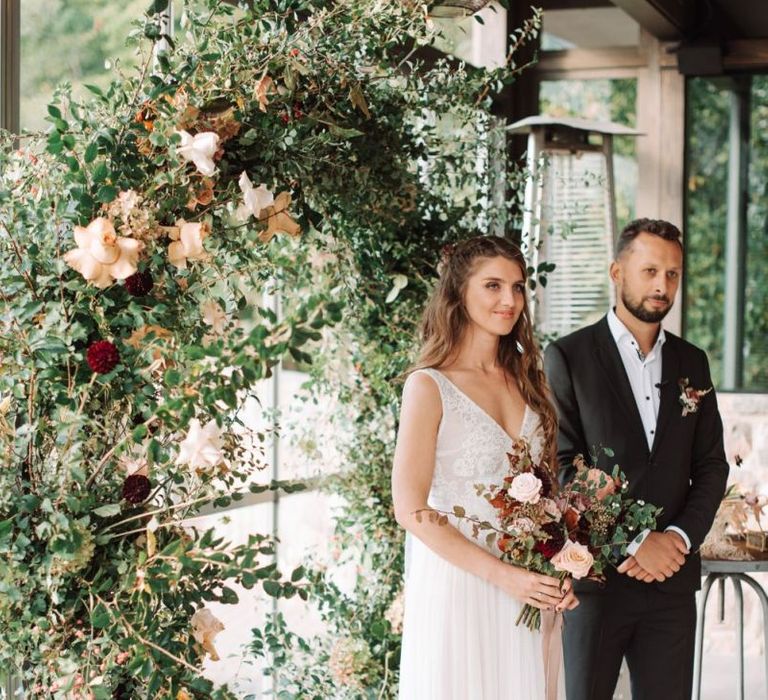 Wedding Ceremony with Bride in Katya Katya Wedding Dress and Groom in Black Suit Standing at the Altar