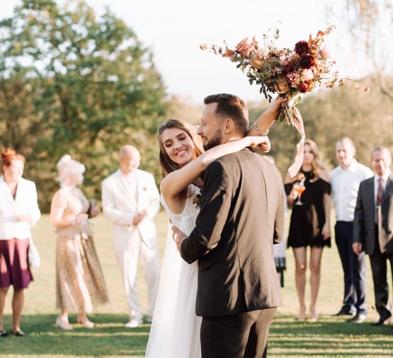 Outdoor First Dance with Bride in Katya Katya Wedding Dress and Groom in Black Suit