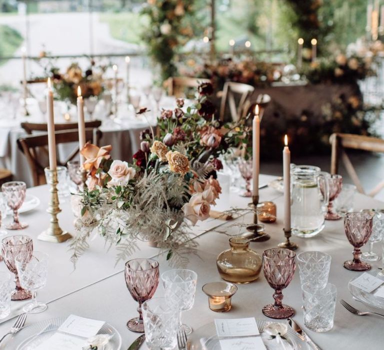 Blush Pink Wedding Reception Table Decor with Taper Candles and Floral Arrangement