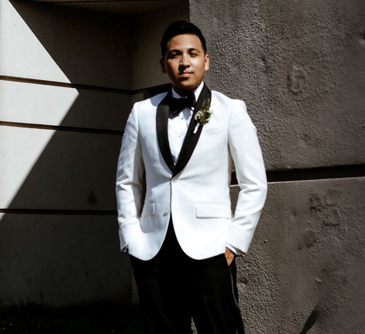 Same sex wedding with grooms in white dinner jackets