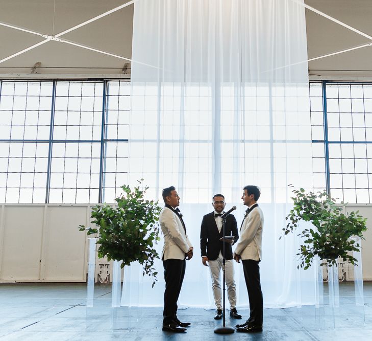 Industrial wedding ceremony in an airplane hangar in Seattle