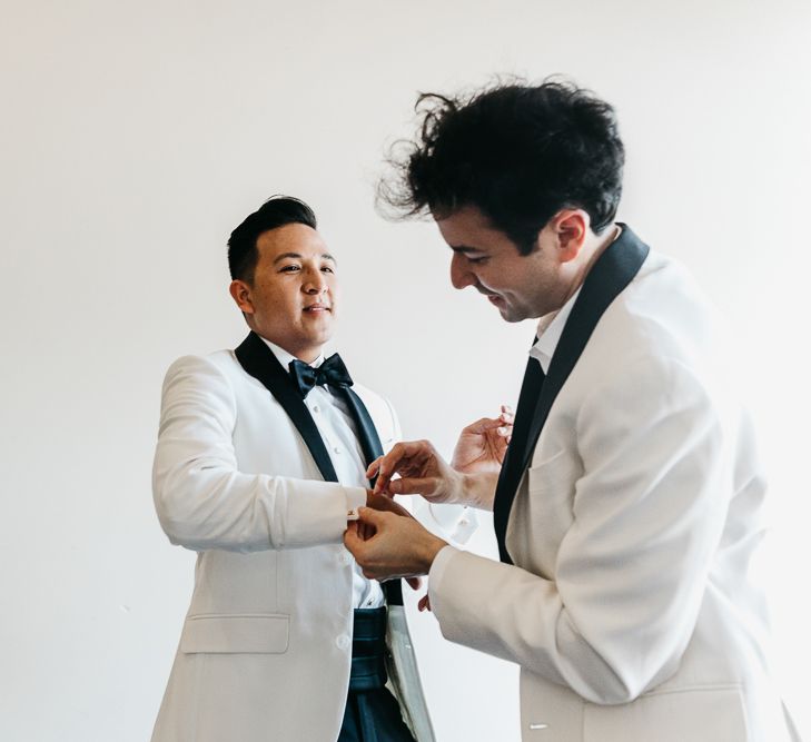 Groom and groom in white tuxedo dinner jackets