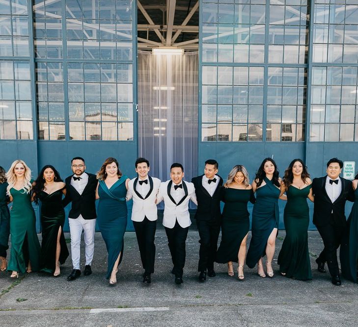 Wedding party portrait outside an airplane hangar industrial wedding venue