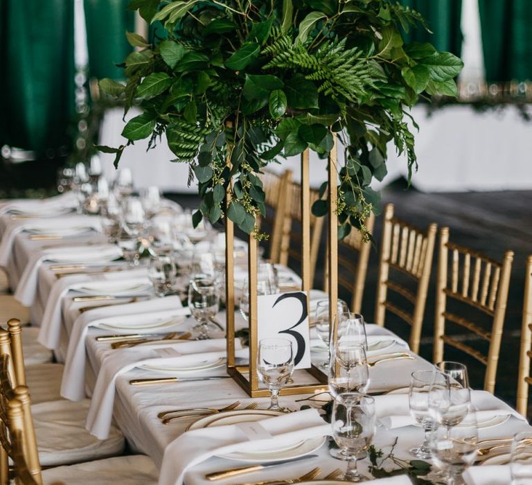 Tall foliage table centrepiece at industrial wedding