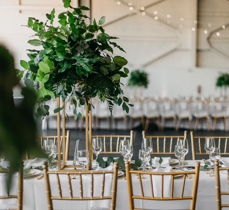 Gold and green wedding decor at and industrial wedding