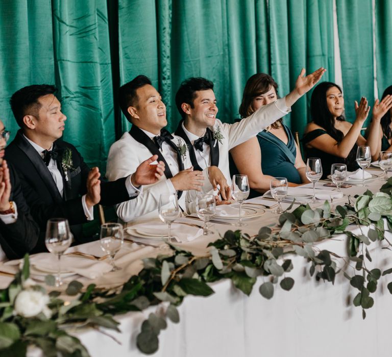 Grooms at the top table with their wedding party