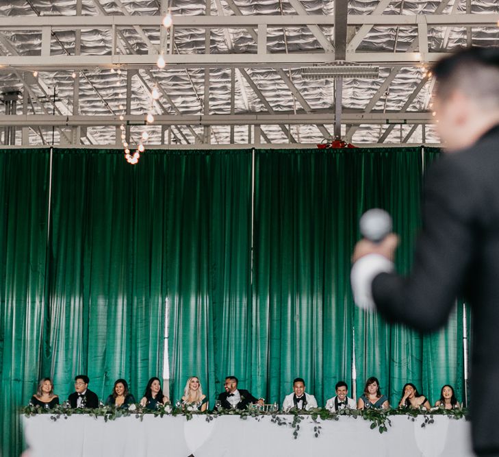 Grooms laughing during wedding speeches