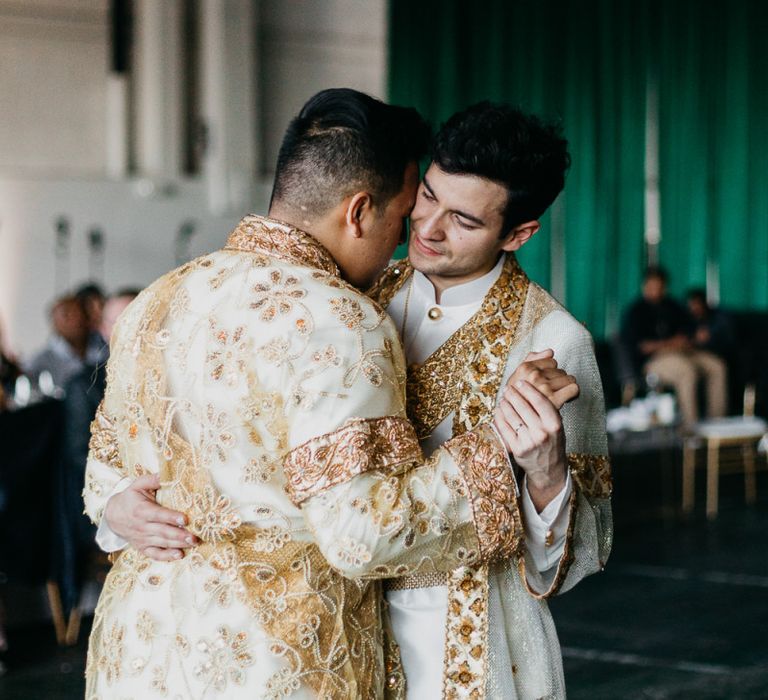 Groom and groom dancing in traditional Cambodian outfits