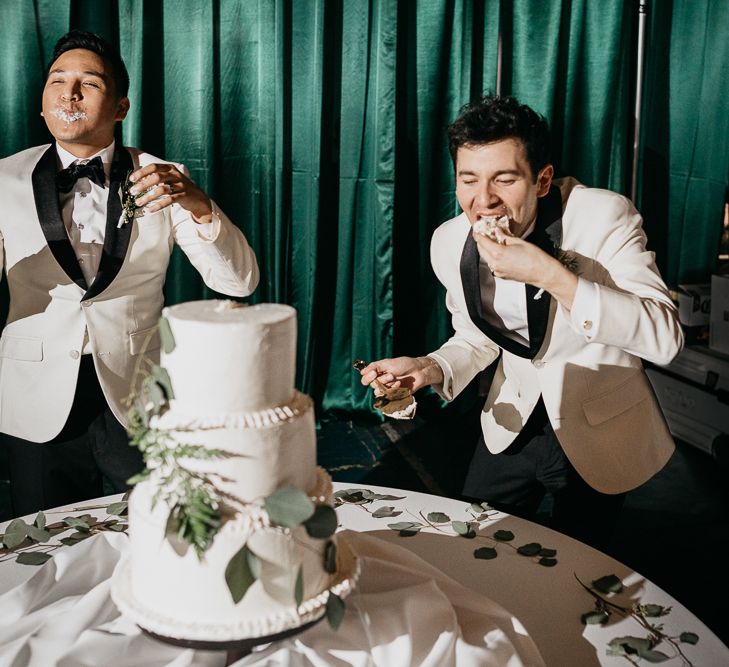 Groom and groom eating the homemade wedding cake